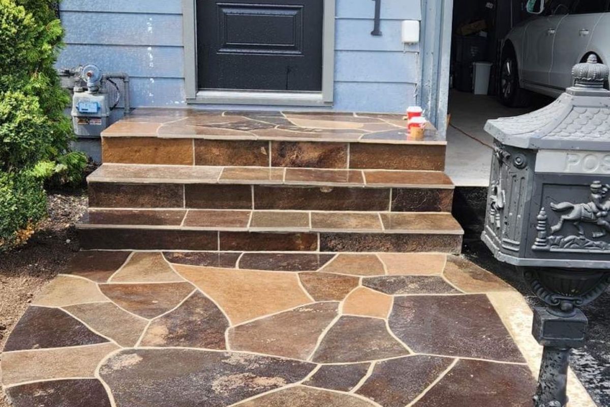 Flagstone front steps and landing leading up to a dark front door